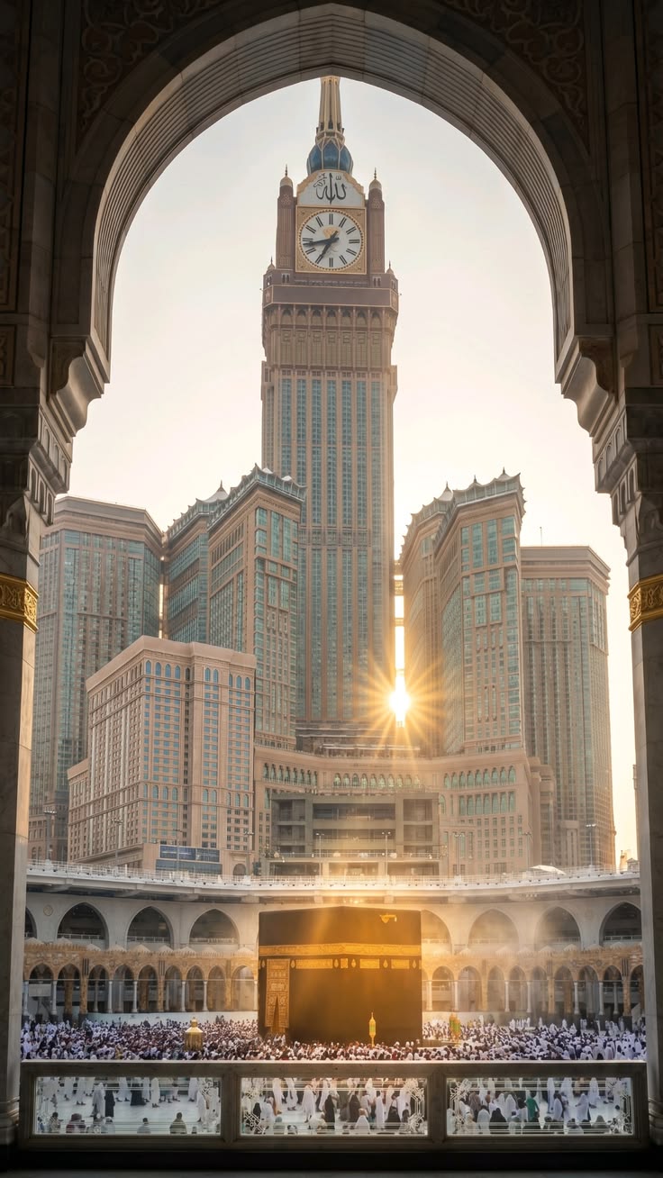 The Kaaba at sunrise, framed by an arch of the Haram