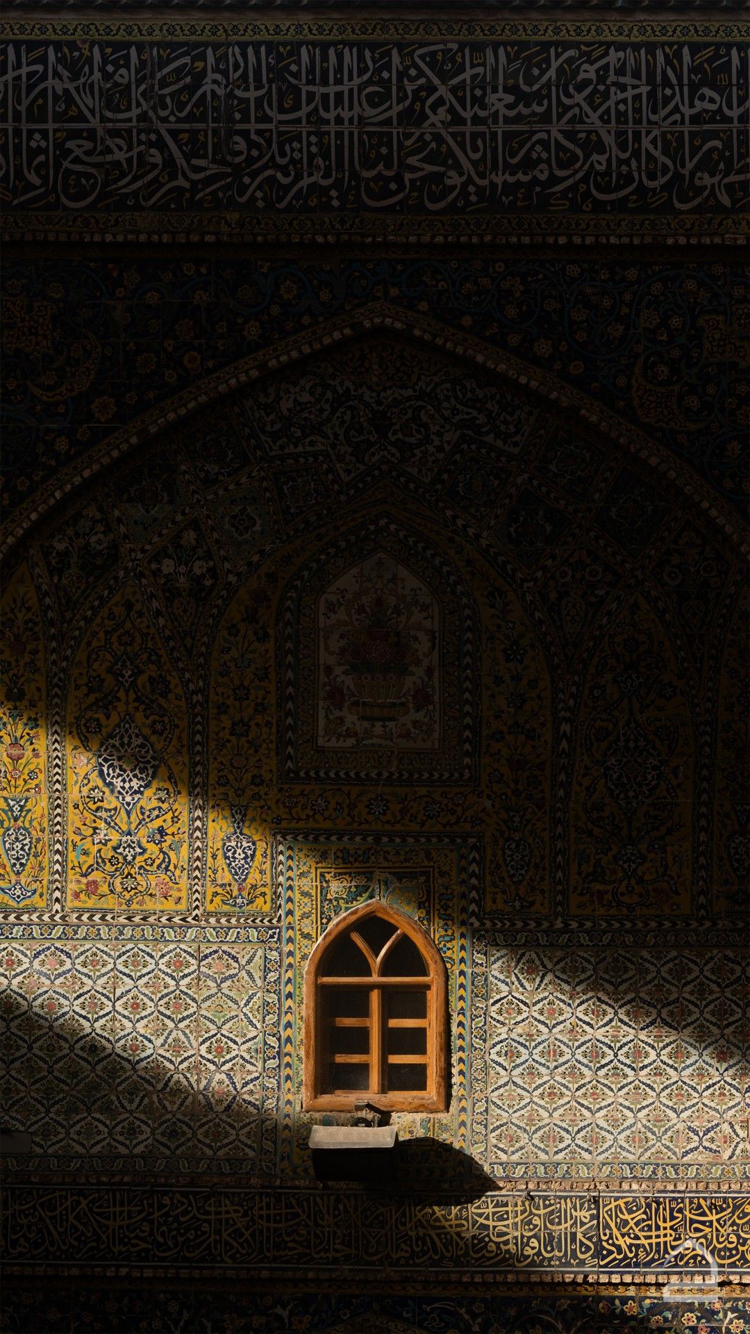A tiled façade with an arched window