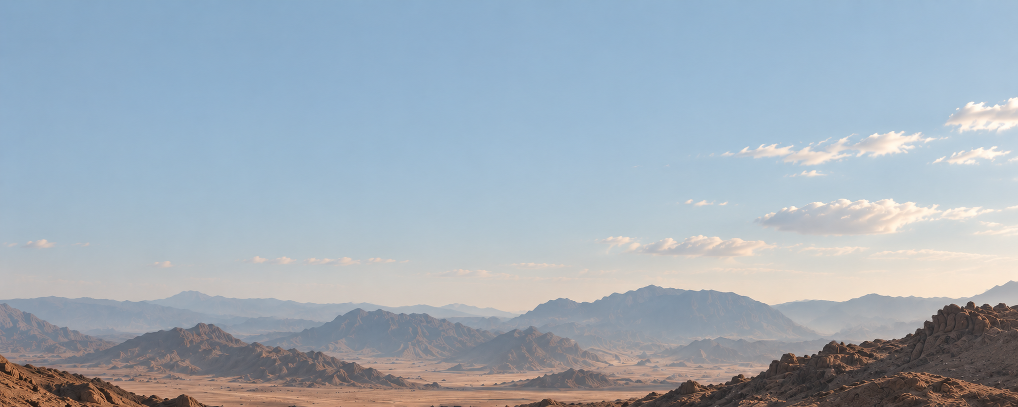 Desert mountains under a wide morning sky